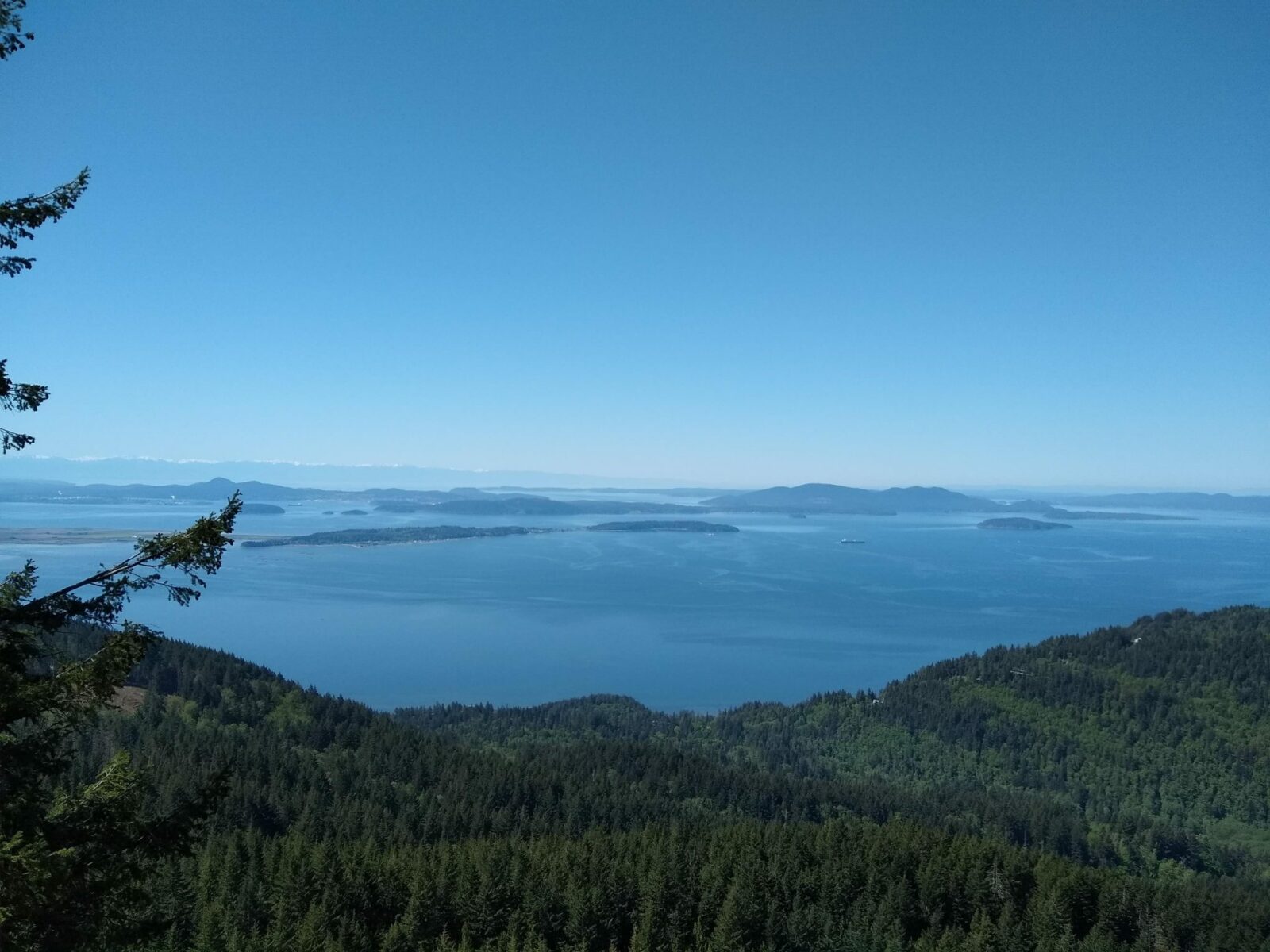 A view from a high place over water and distant islands on a sunny day