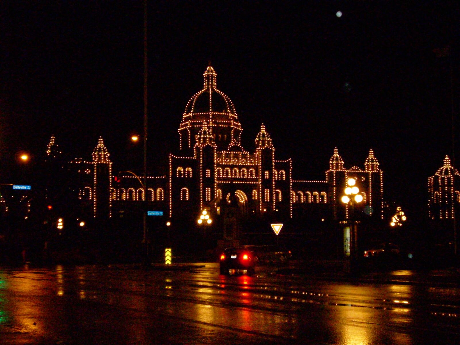 The British Columbia Parliament building at night with white lights outlining the building