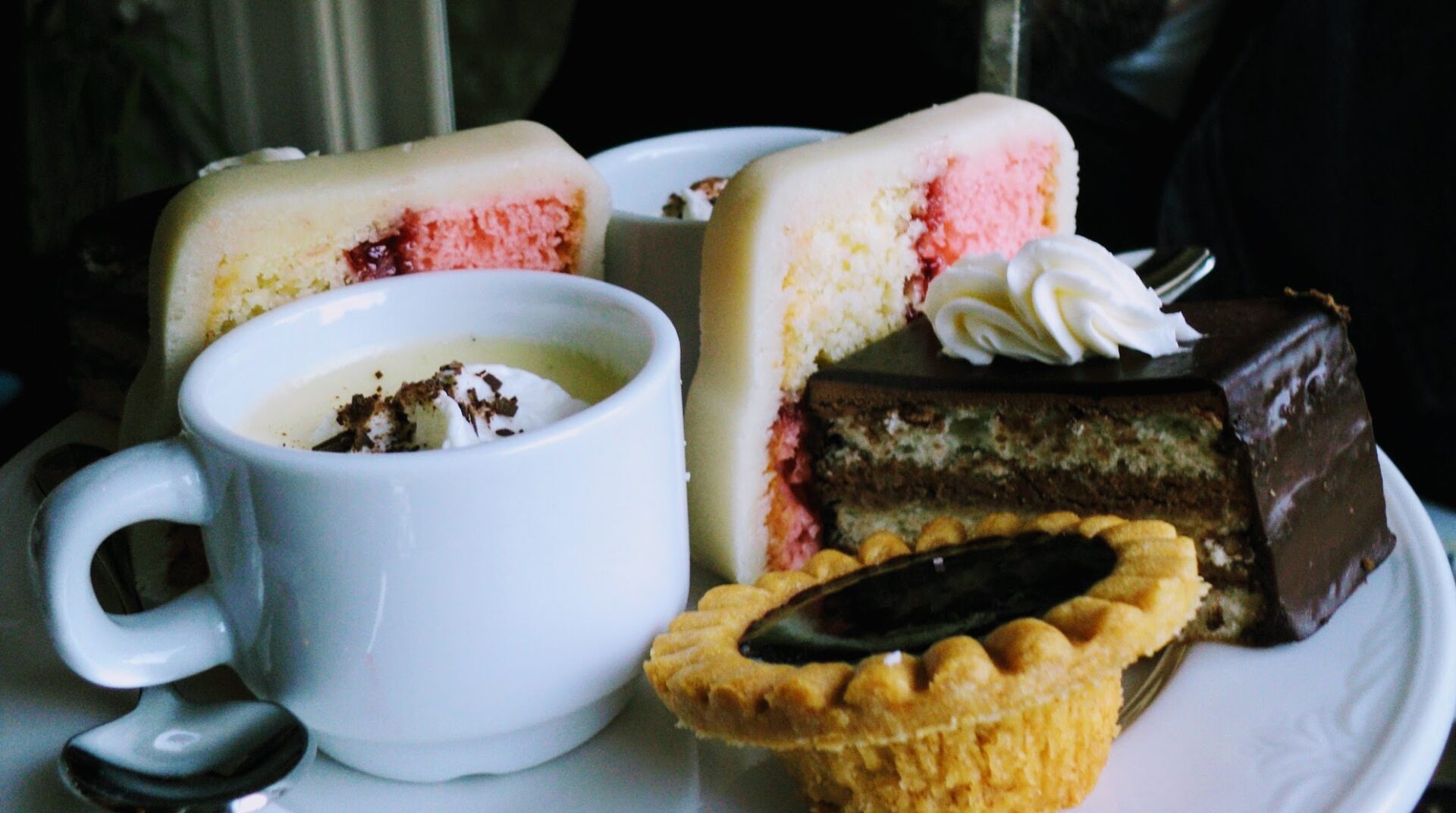 a selection of desserts on a white plate