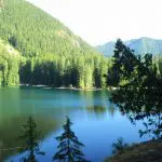 Lena Lake, an alpine lake on a sunny day surrounded by forested hillsides