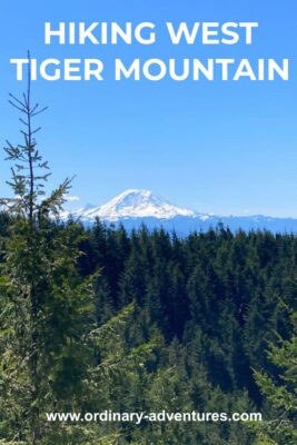 Mt Rainier in the distance on a sunny day. There is a forested hillside in the foreground. Text reads: Hiking west tiger mountain