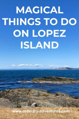 Rocks sticking out into the blue water of the Salish Sea and some rocks exposed just off shore. In the distance is another island. Text reads: magical things to do on lopez island