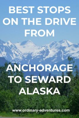 Forest in the foreground, hills and water in the background and high snow capped mountains in the distance at Turnagain Pass in Alaska on a sunny day. Text reads: Best stops on the drive from Anchorage to Seward Alaska