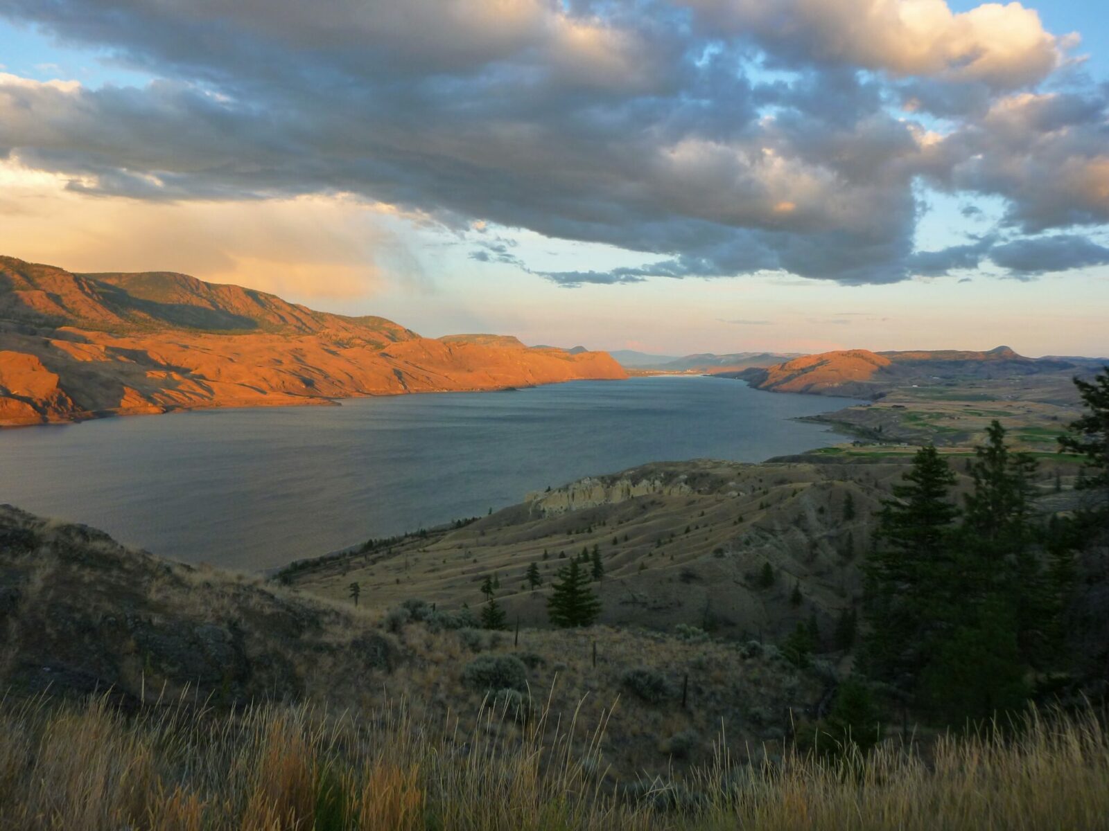 A lake partly in shadow and partly in the light of the setting sun.