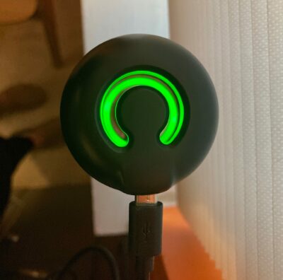 The top of the charger for the CrazyCap 2 water bottle with a green light ring on top