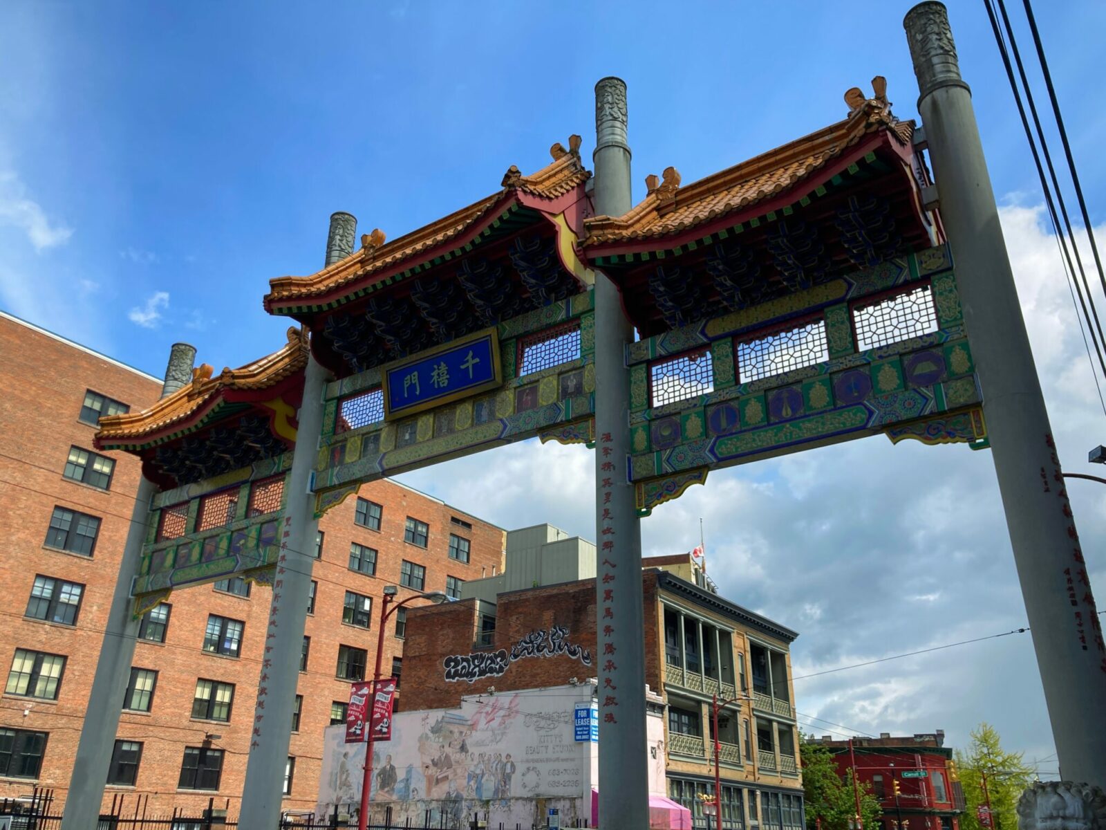 A large three section Chinese gate marking the entrance to Chinatown in downtown Vancouver.