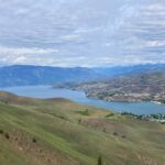 The view of Lake Chelan and North Cascades Mountains from Elephant Head. On the hillside below you can see the trail winding up and the town of Chelan below next to the lake.