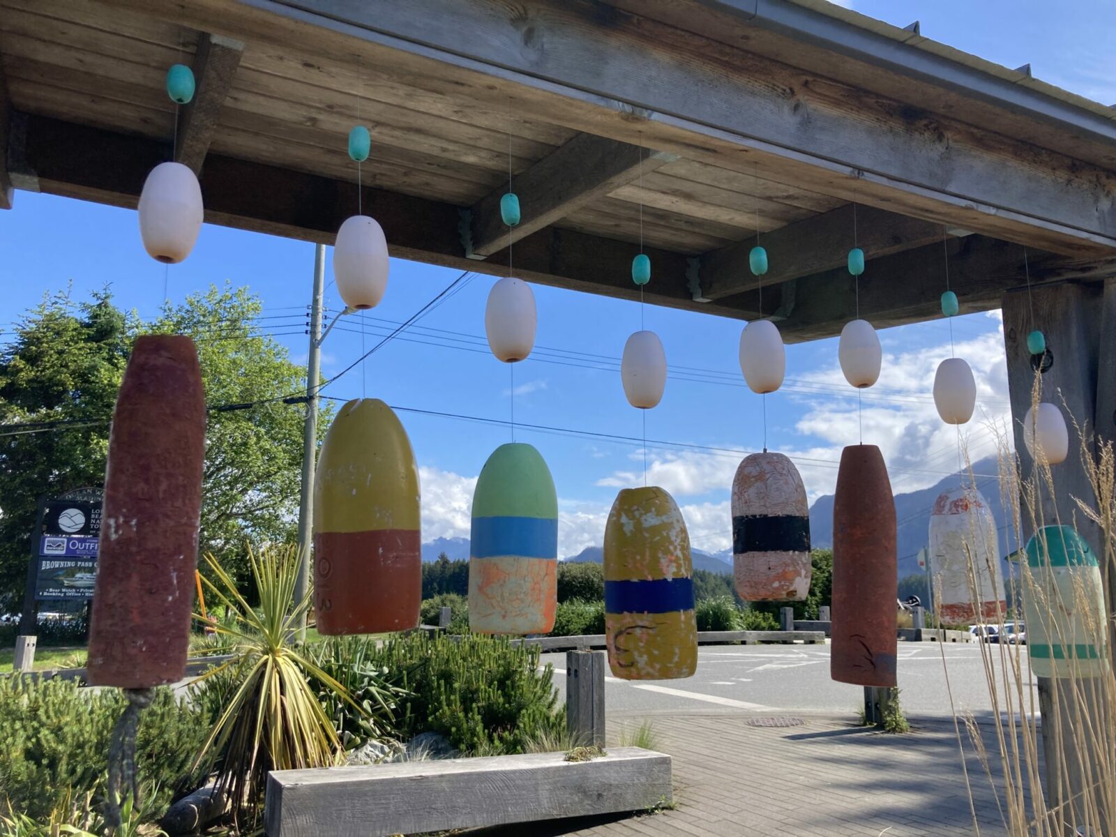 Hanging colorful buoys from a wooden structure in downtown Tofino.