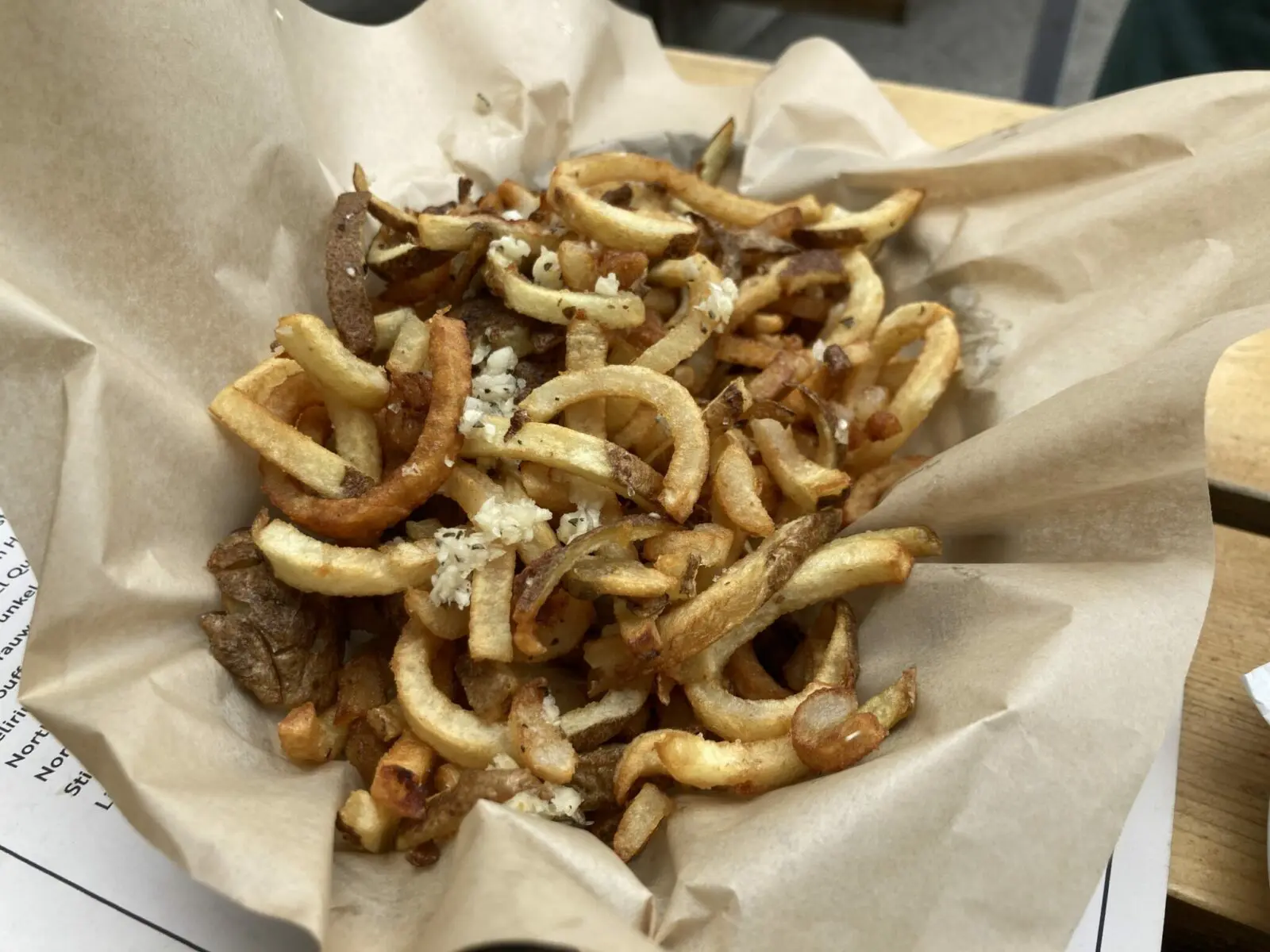 a basket of french fries with garlic and rosemary
