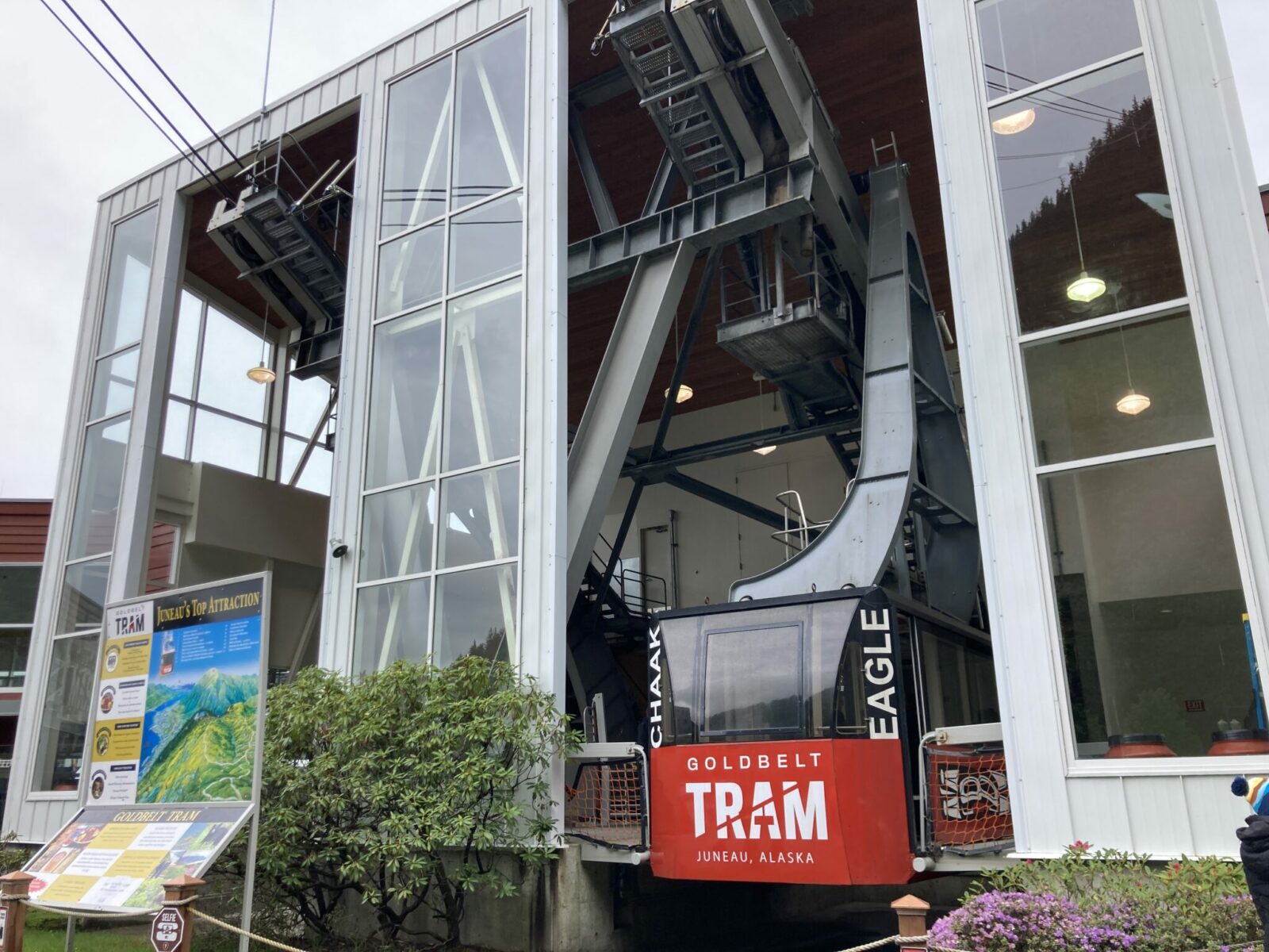 A tram base with large windows and a tram car getting ready to depart