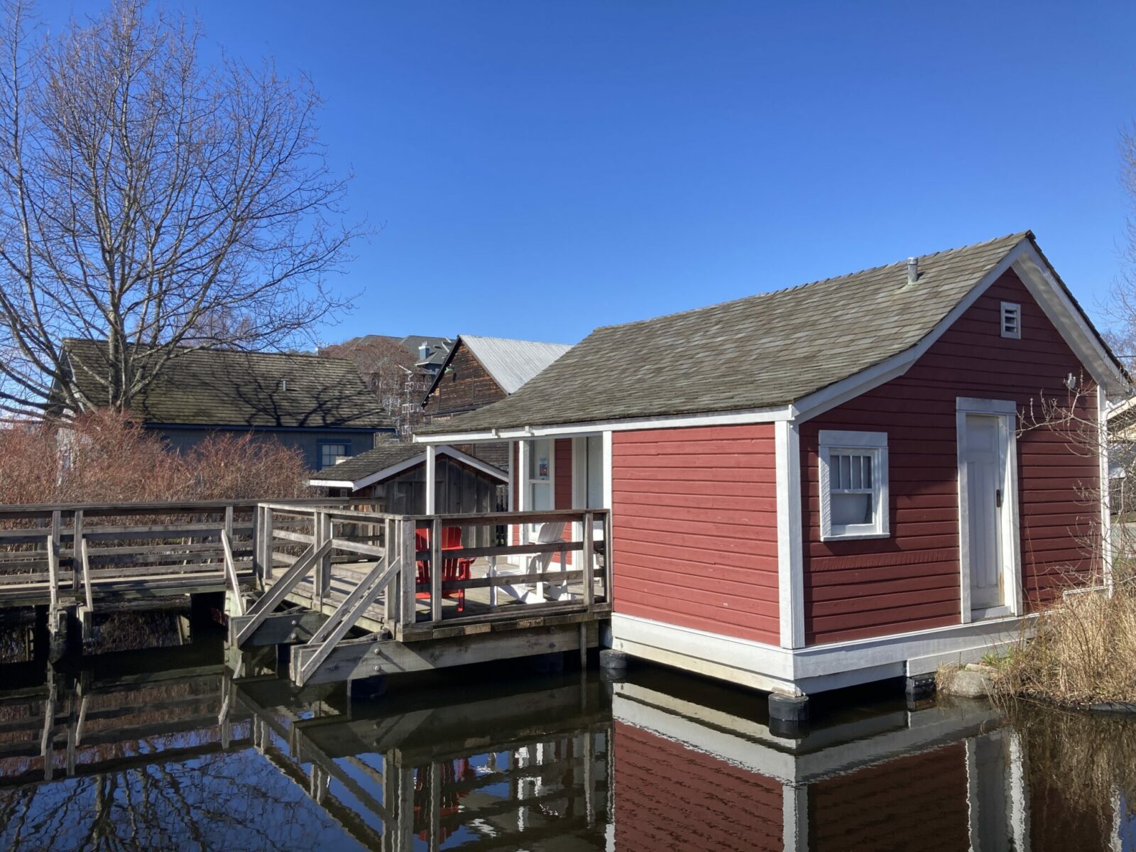 A floating red and white wooden house