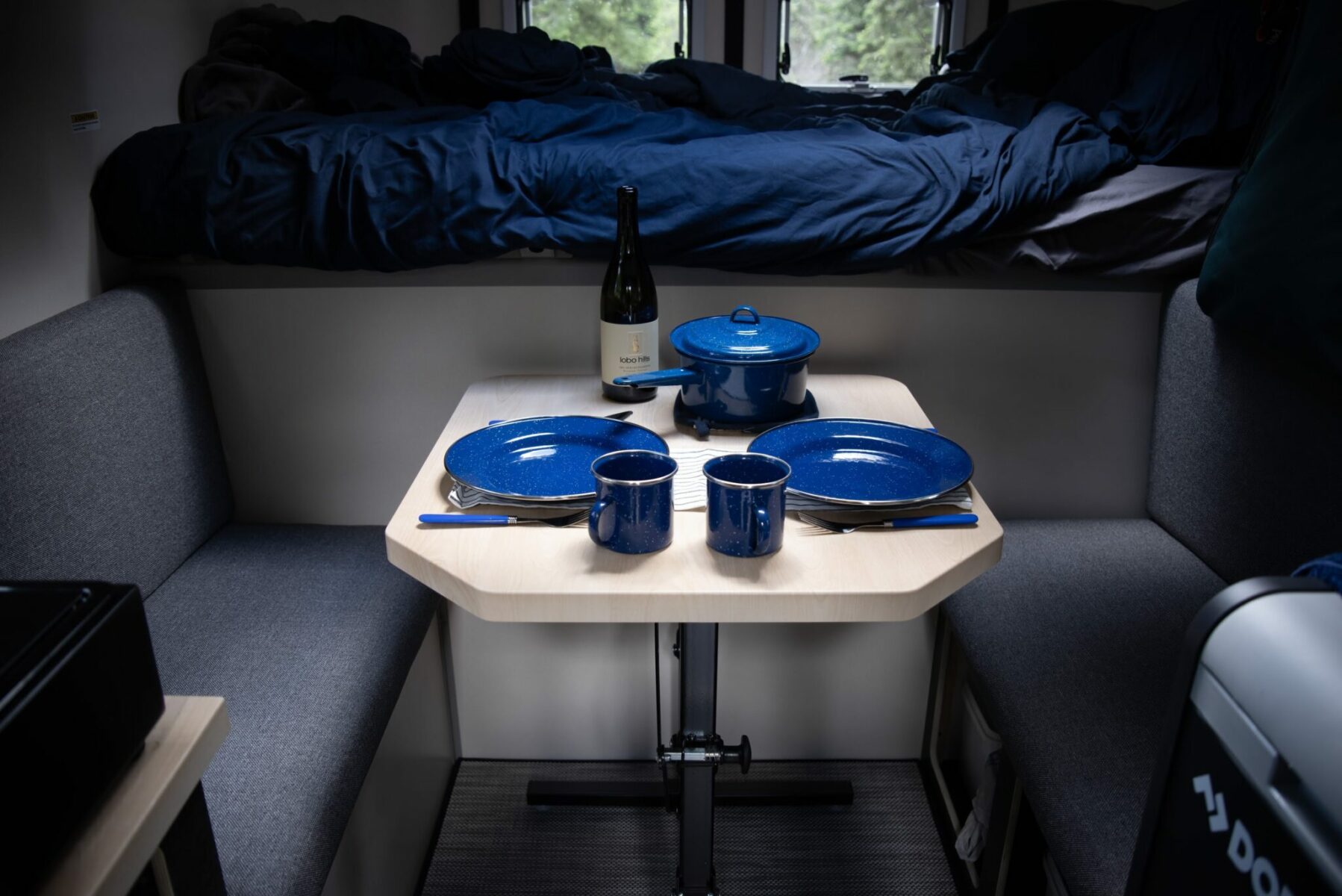 A table set for two inside a pick up camper