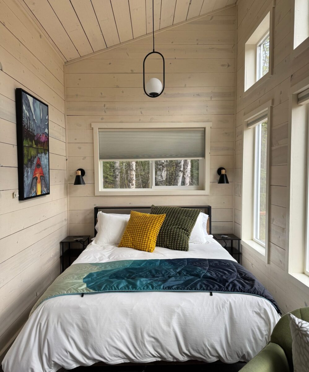 A cozy bed in a BlueWater BaseCamp chalet