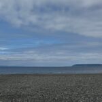 Meadowdale Beach, a gravel beach on the Salish Sea with islands in the distance on a partly sunny day