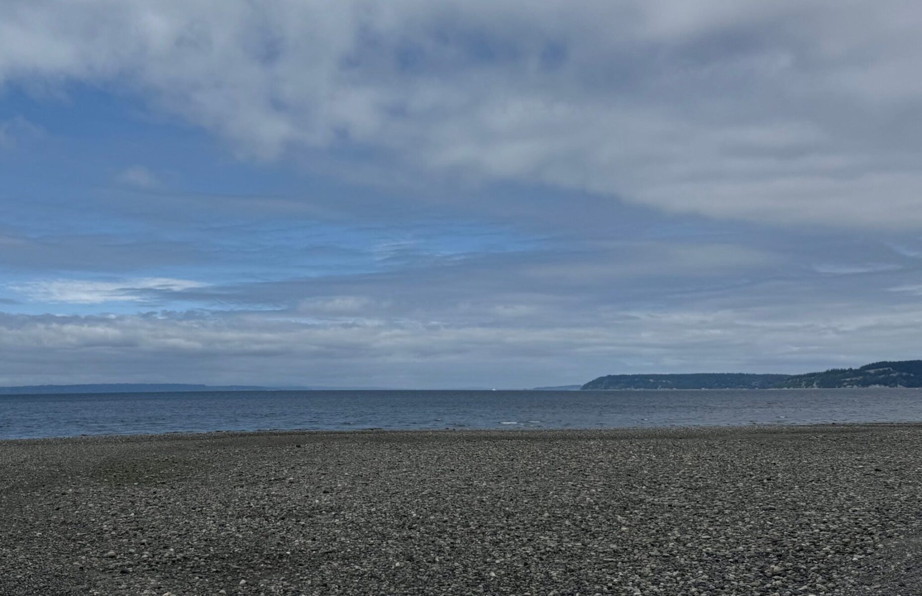 Meadowdale Beach, a gravel beach on the Salish Sea with islands in the distance on a partly sunny day