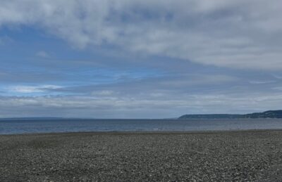 Meadowdale Beach, a gravel beach on the Salish Sea with islands in the distance on a partly sunny day