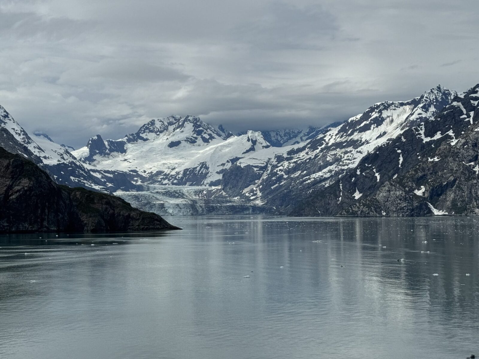 A glacier and mountains on a gray day in Glacier Bay National Park