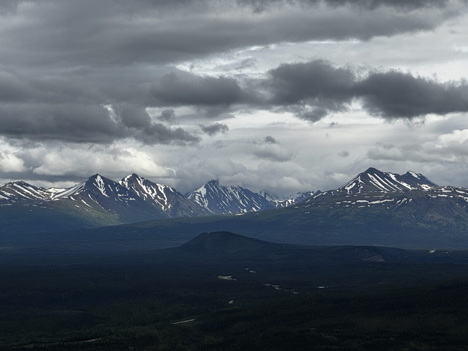 View of distant mountains on a cloudy day from a hike in Denali National Park